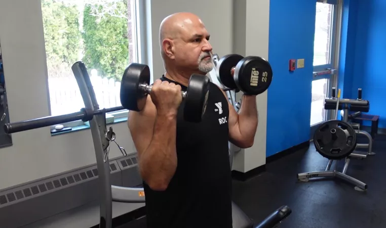 a ymca member exercising with dumbbells