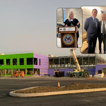 the exterior of the under-construction sands family ymca with images of NYS Senetors Charles Schumer and Kristen Gillibrand and YMCA Chief Development Officer Andy Powers