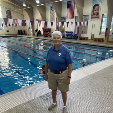 a photo of board member shannon standing in front of the northwest ymca lap pool