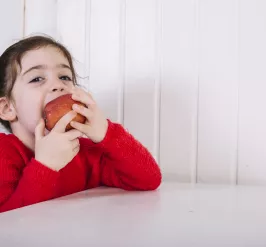 young girl eating an apple