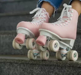a close up of a pair of pink roller skates 