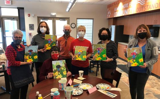 Group holding paintings from Painting with Pizzazz