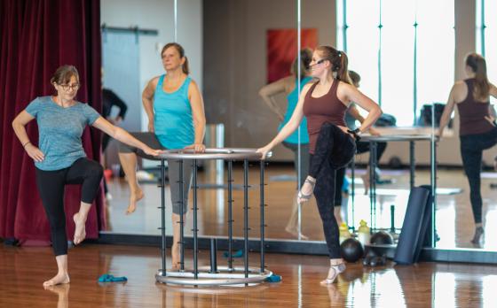 an instructor and two women in a barre class at the schottland family ymca