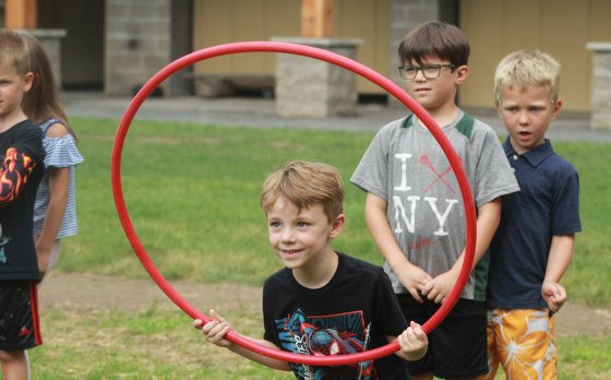 Kid Jumping through Hoola Hoop