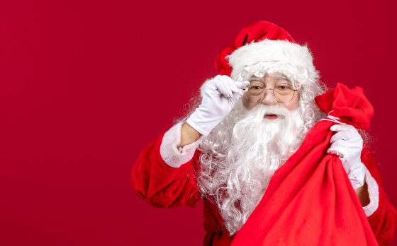 Santa with a red background holding a red sack