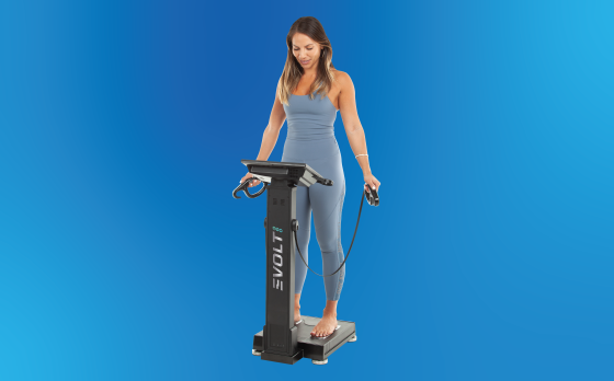 woman standing on "evolt" body scanner with blue background