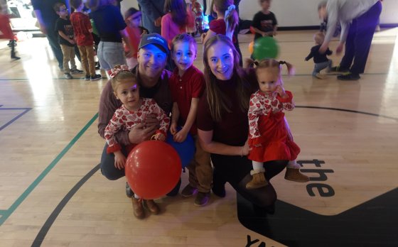 A family poses for a picture at the Y Not Valentine's Day Dance.
