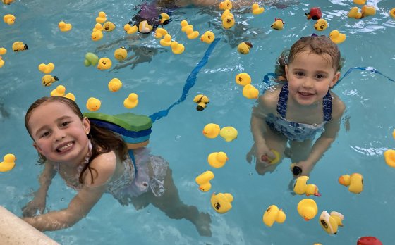 Children swimming with rubber ducks