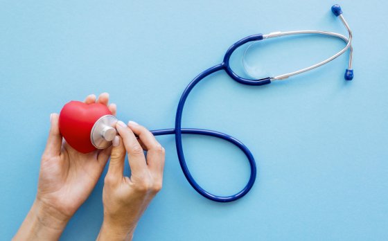 hands checking heart shape with stethoscope