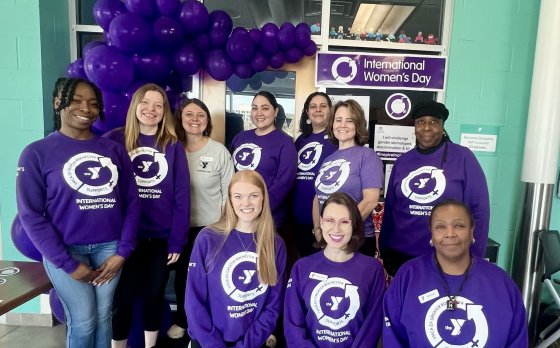 Group of women pose together for a picture.