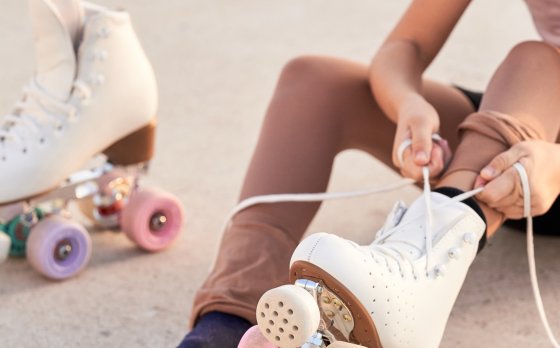 kid tying roller skates