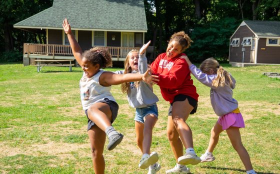 campers dancing around in field