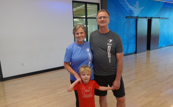 Ruffing family posed together holding hands in the gymnasium