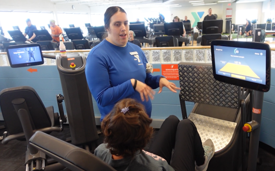 Amanda MacDonald helping a member in the Wellness Center
