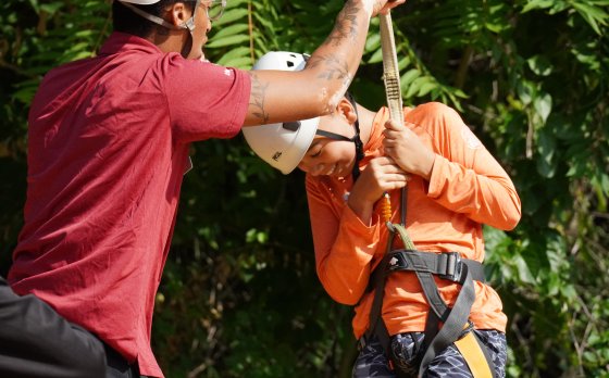 Bay View Staff helping kid with zipline