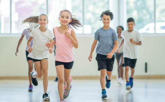 children running in a gymnasium