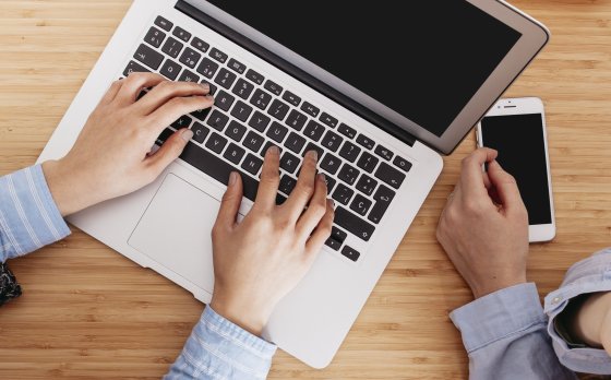 two people using a phone and a computer together