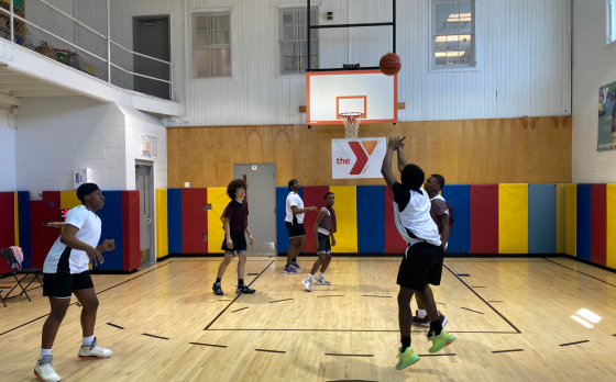 people playing basketball in the gymnasium