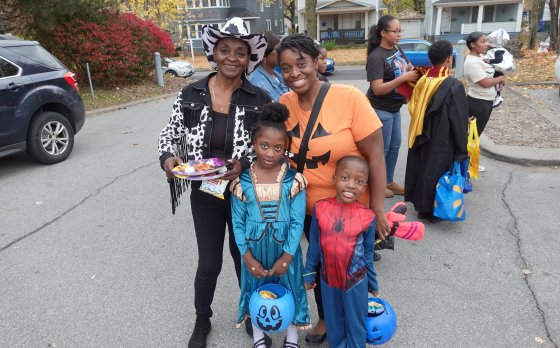 Family dressed in halloween costumes and trick or treating