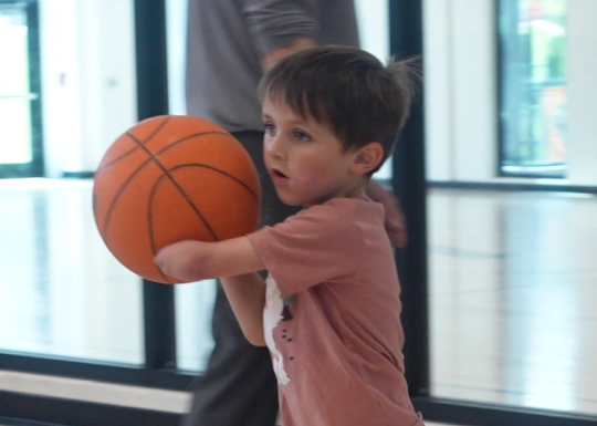 a young member playing basketball
