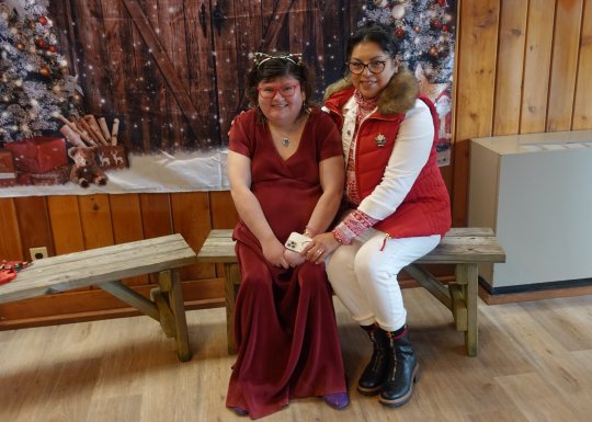 A member and a support staff sitting together at the Winter Wonderland Dance