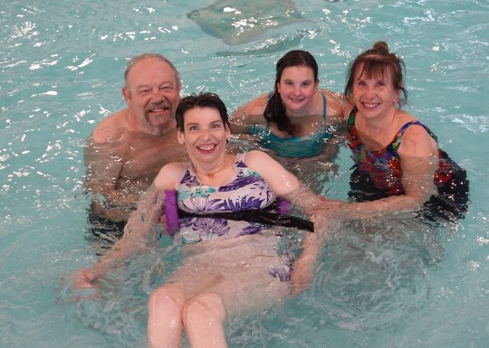 The Gagne family together in the pool posing for a group photo