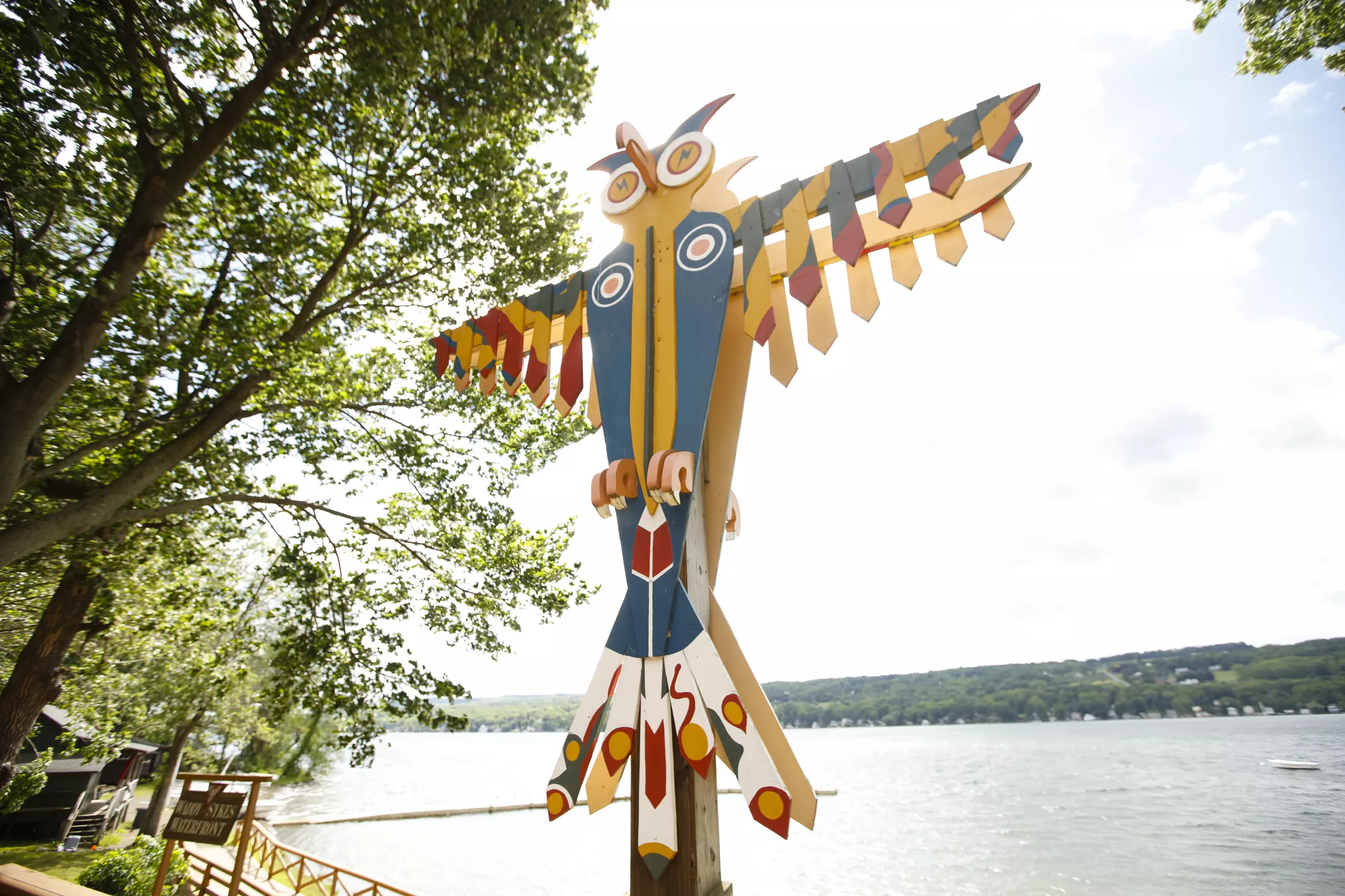 Photo of thunderbird totem at Camp Cory with lake in the background