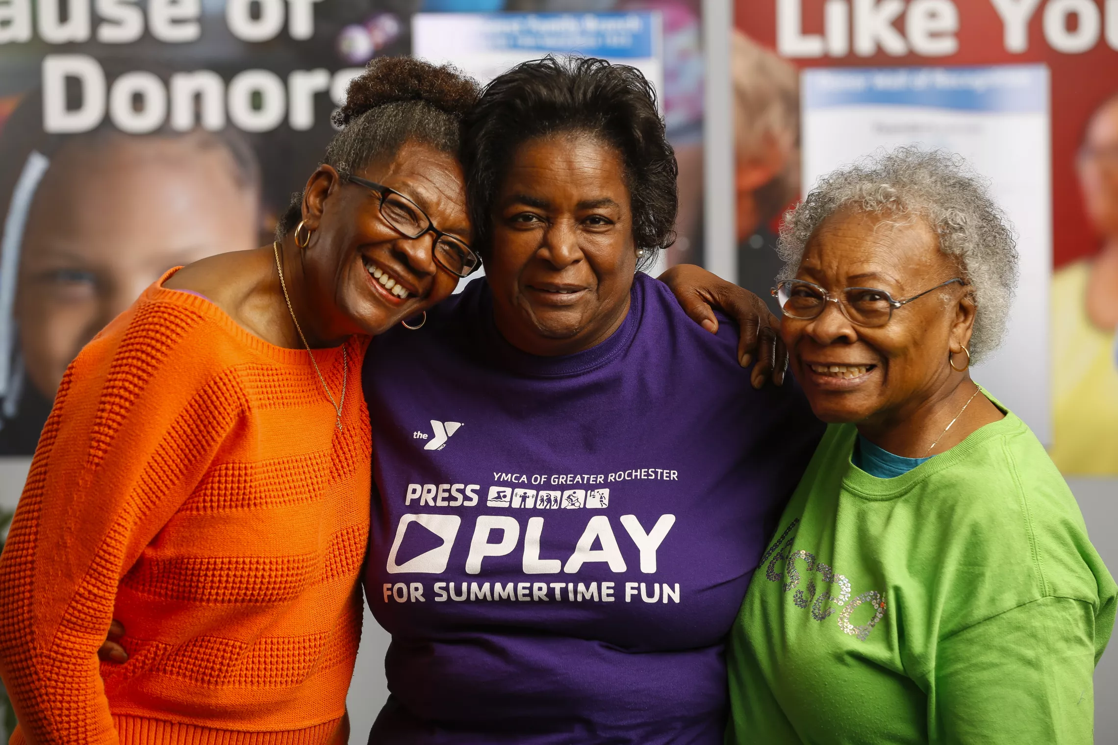 three older women smiling at the camera