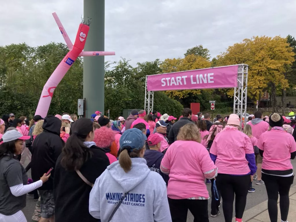a crowd of people at the starting line for the strides against breast cancer walk in Rochester NY