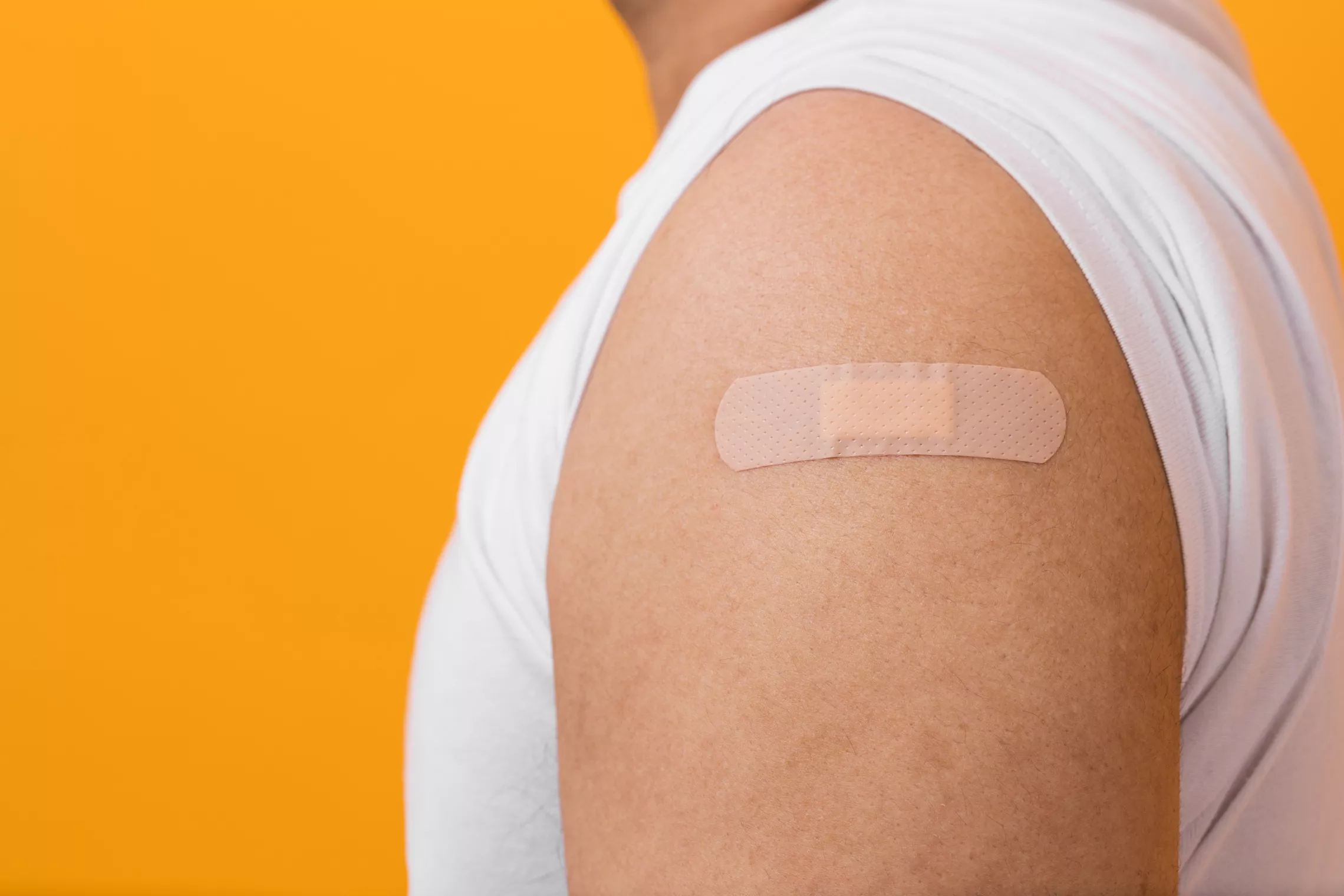 a photo of someone's shoulder with a band aid