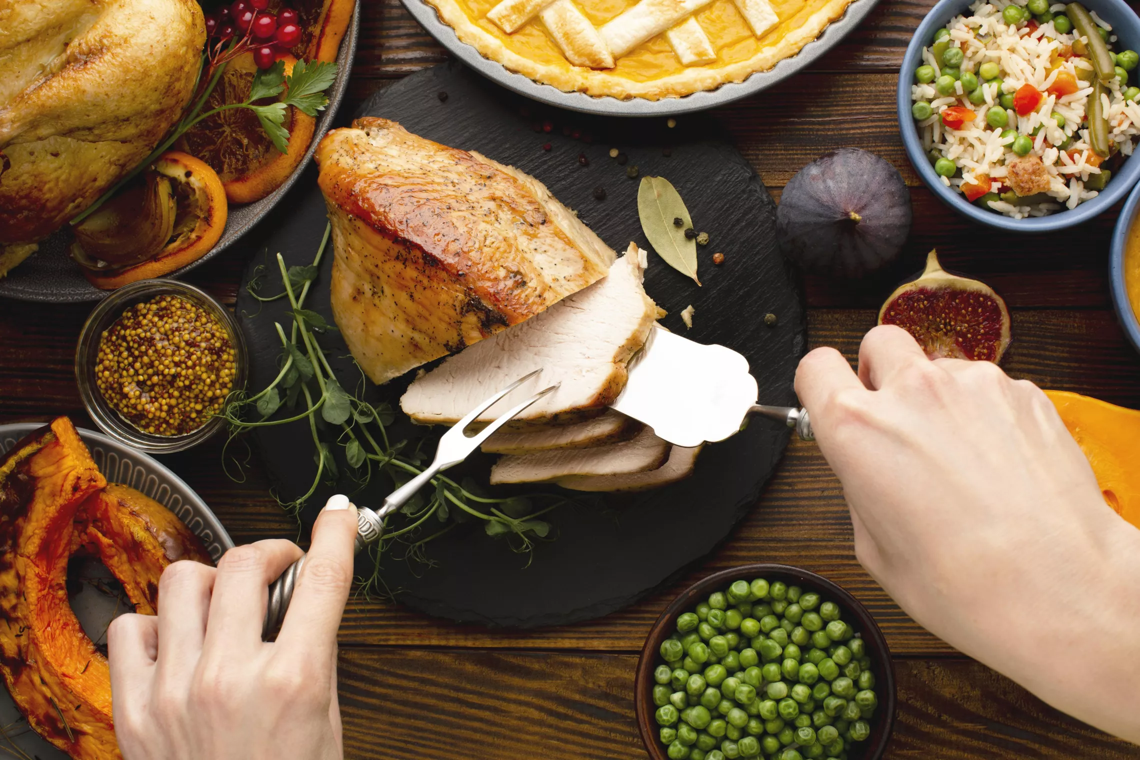 a photo of a thanksgiving dinner with someone serving turkey