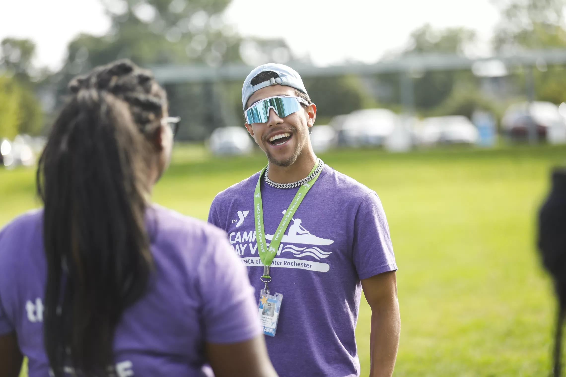 a camp bay view counselor smiling and talking with another counselor