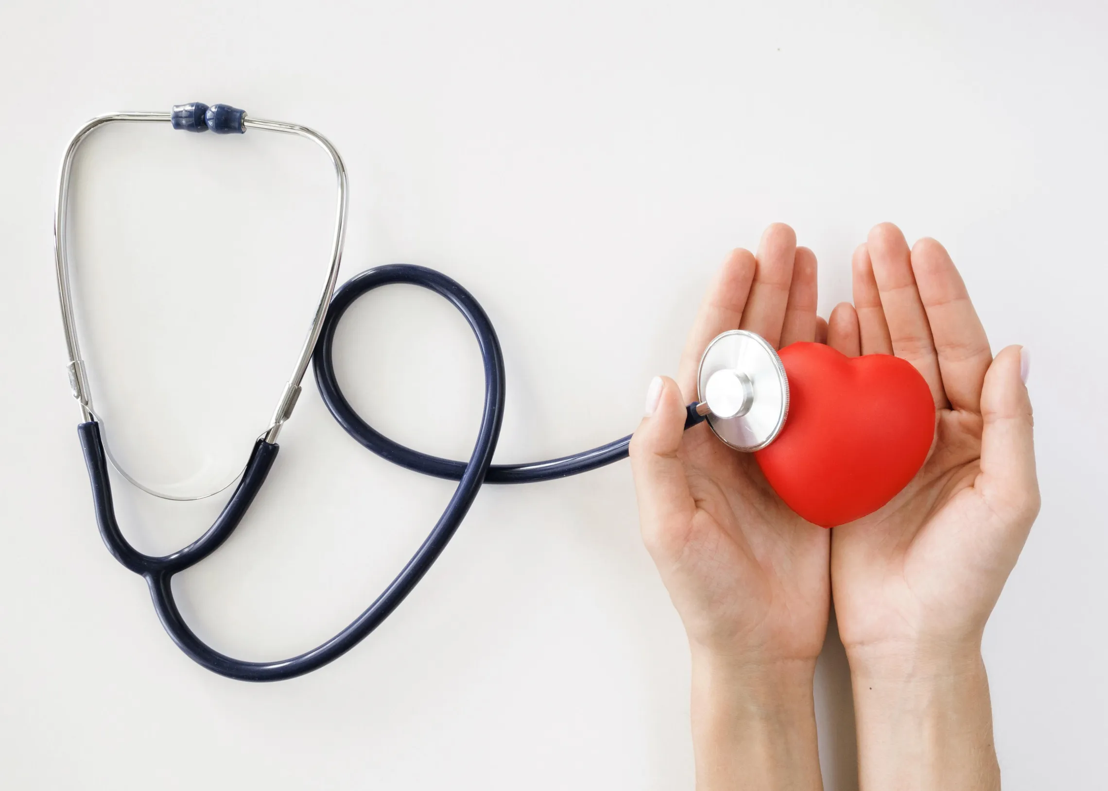 hand holding foam heart with stethoscope
