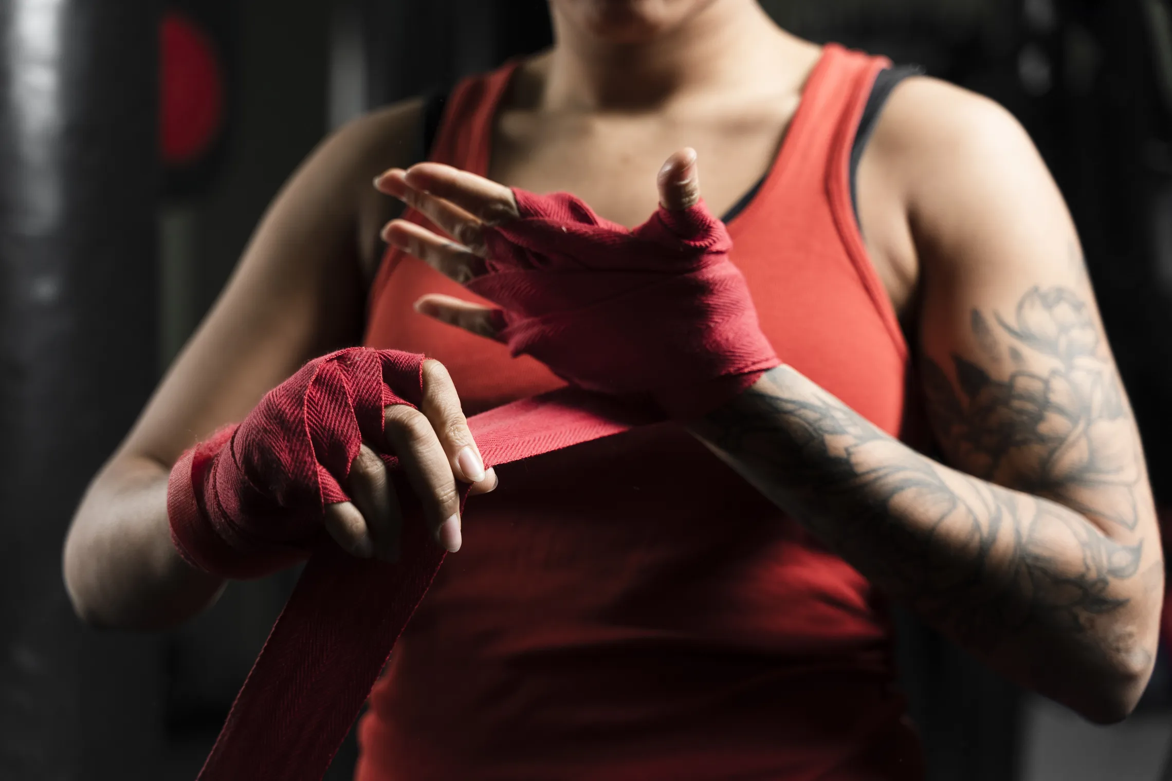 Women lacing up hands for fight training.