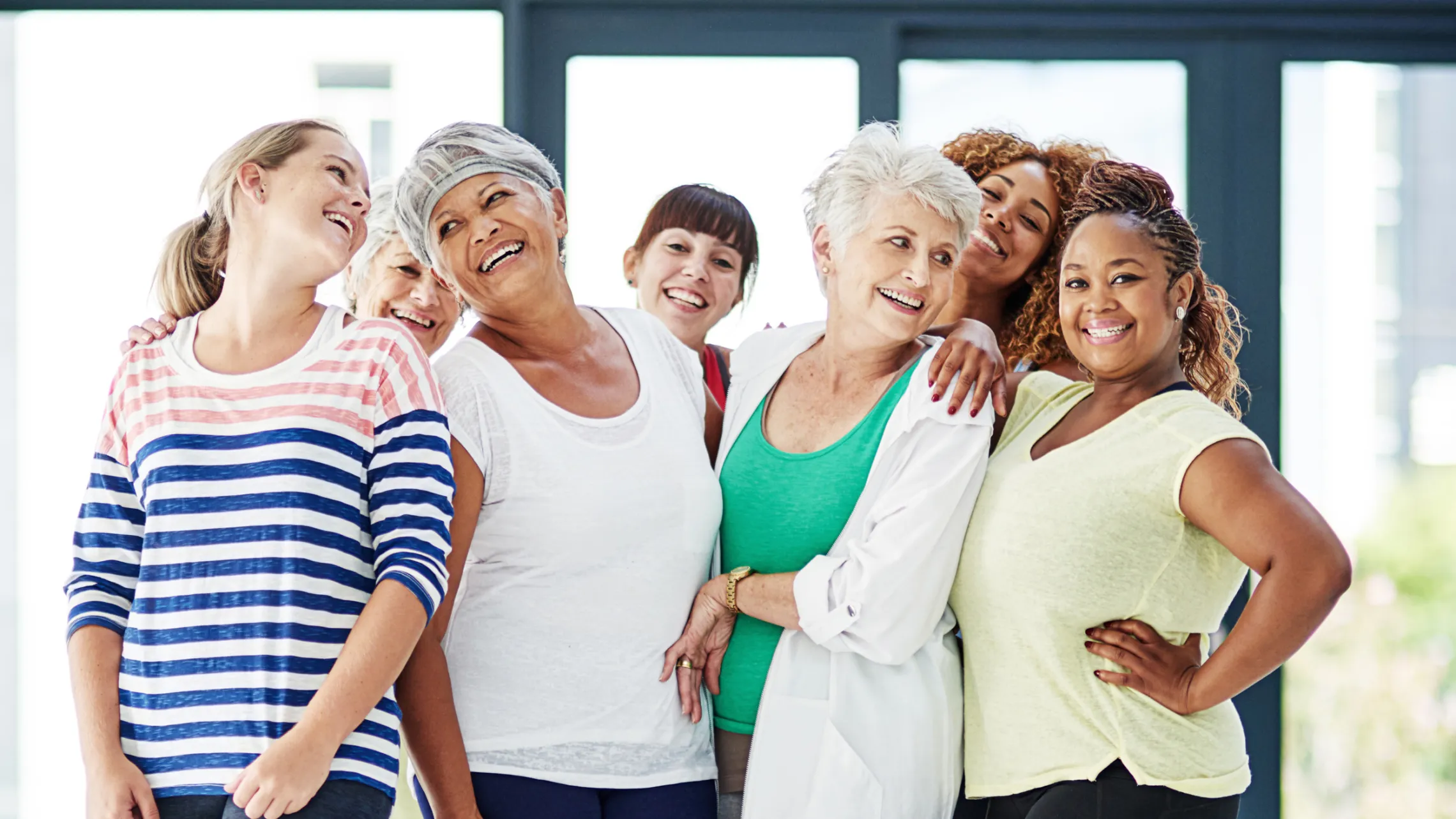 A group of middle-aged and senior women smiling together.