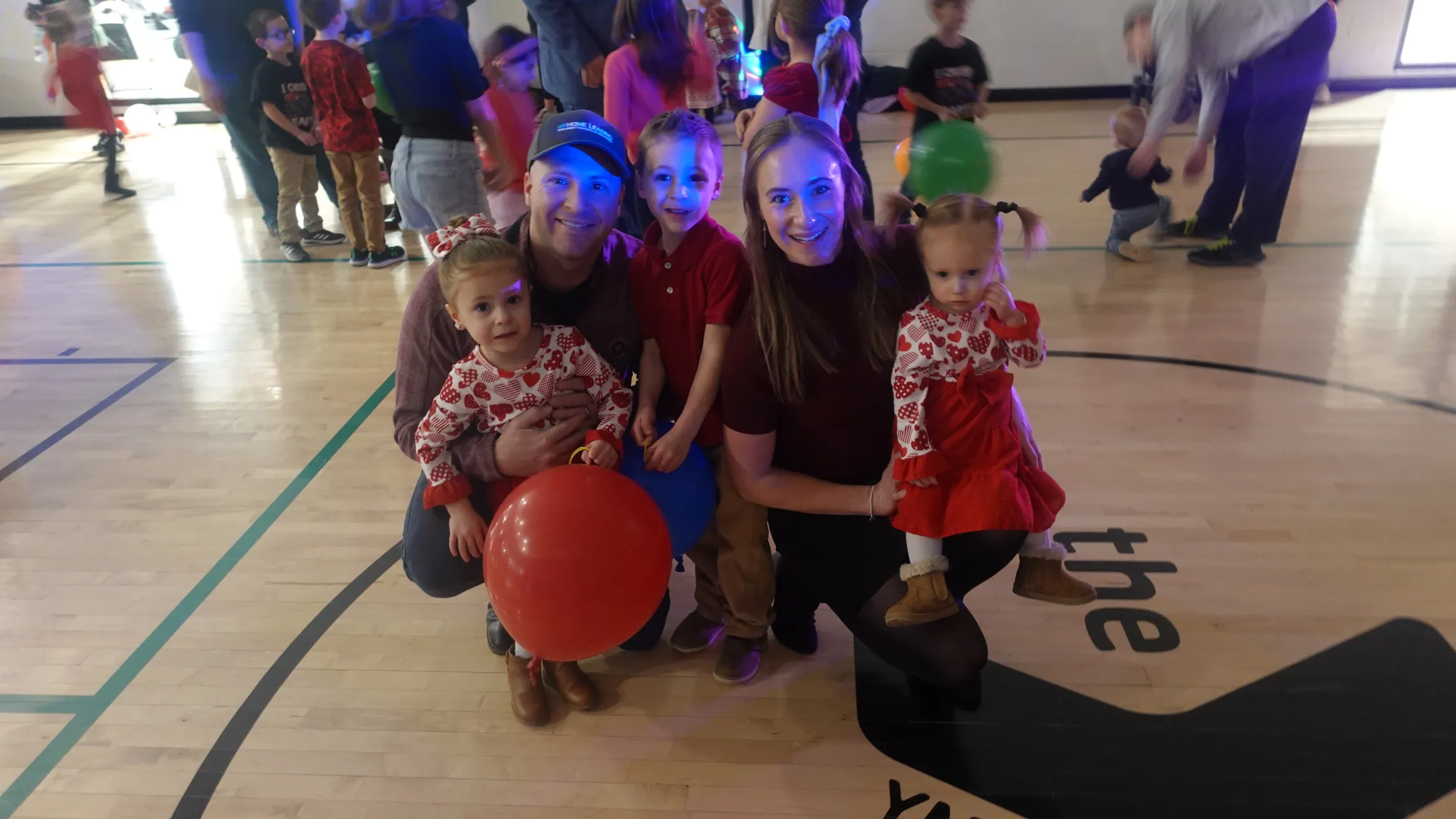 A family poses for a picture at the Y Not Valentine's Day Dance.