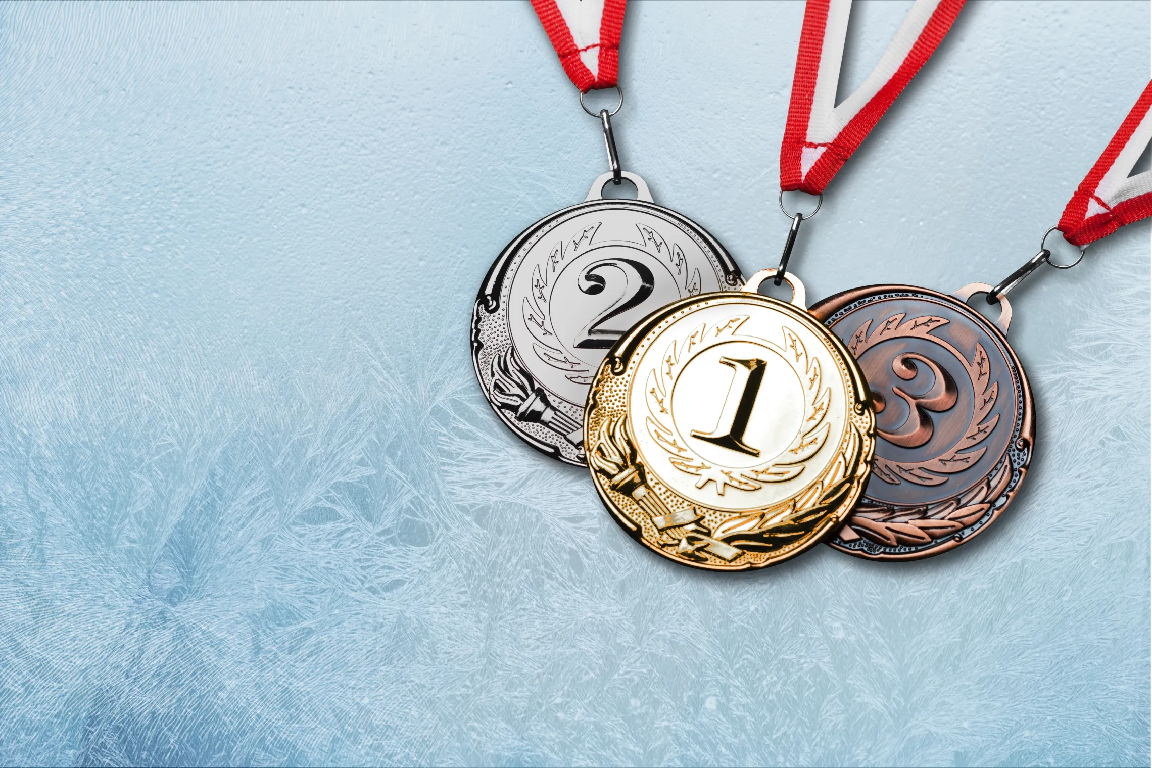 Gold, Silver and Bronze medals on frosted ice