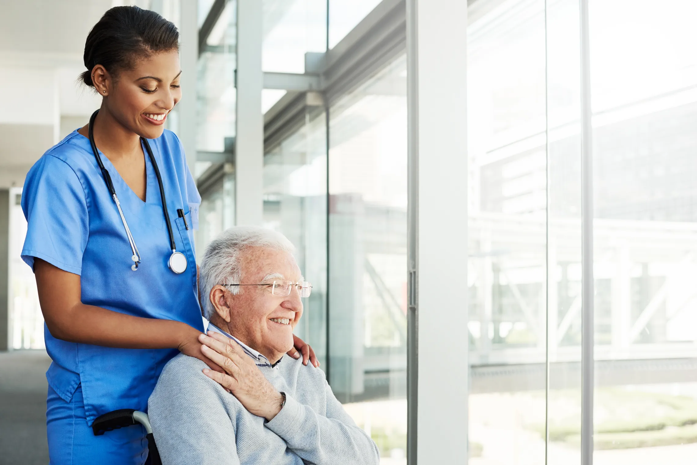 Elderly person in wheel chair with medical professional