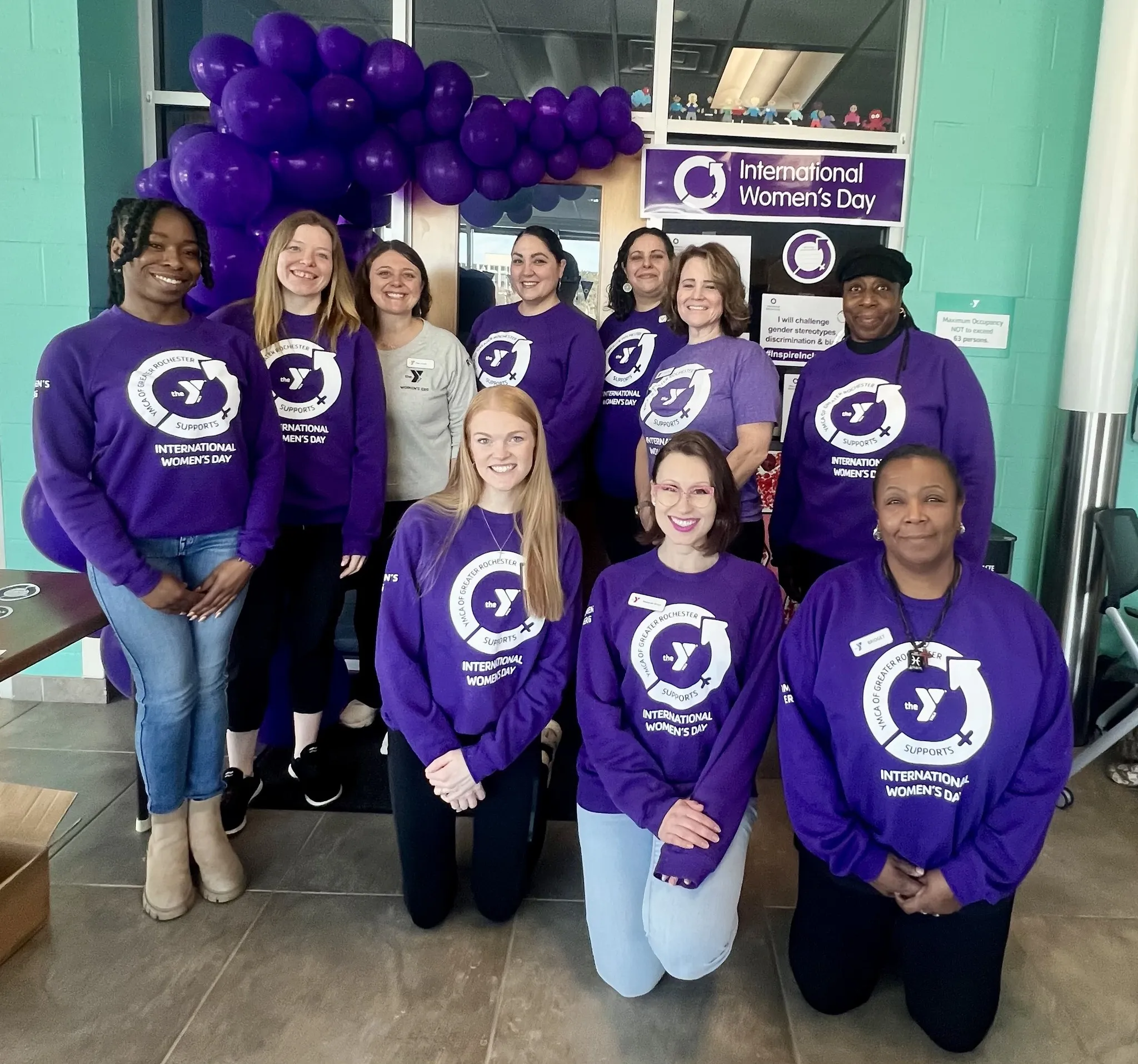 Group of women pose together for a picture.