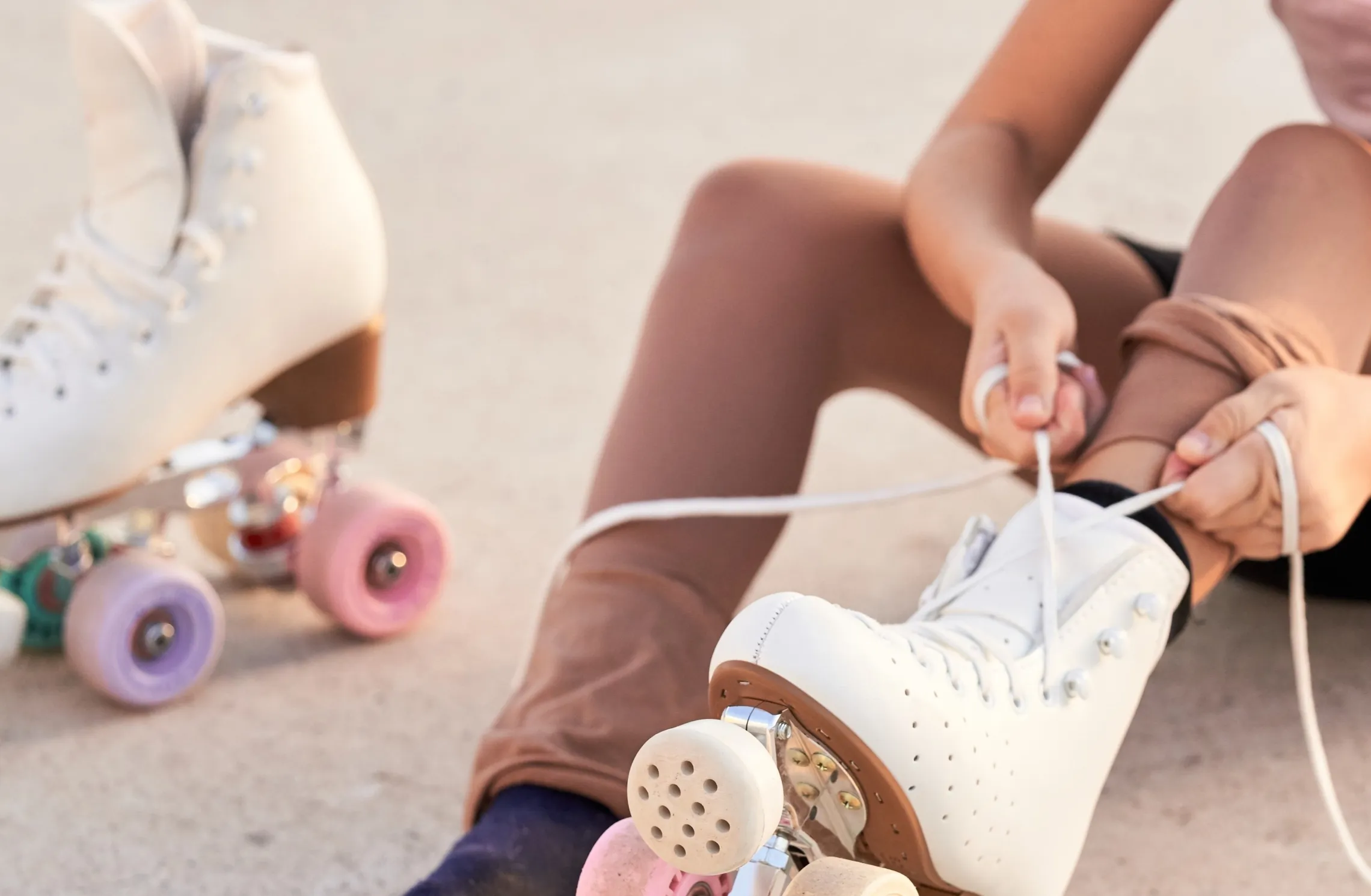 kid tying roller skates