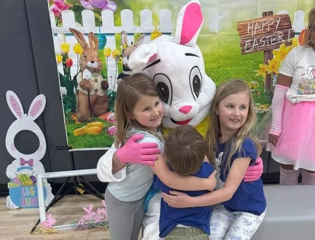 family hugging the easter bunny