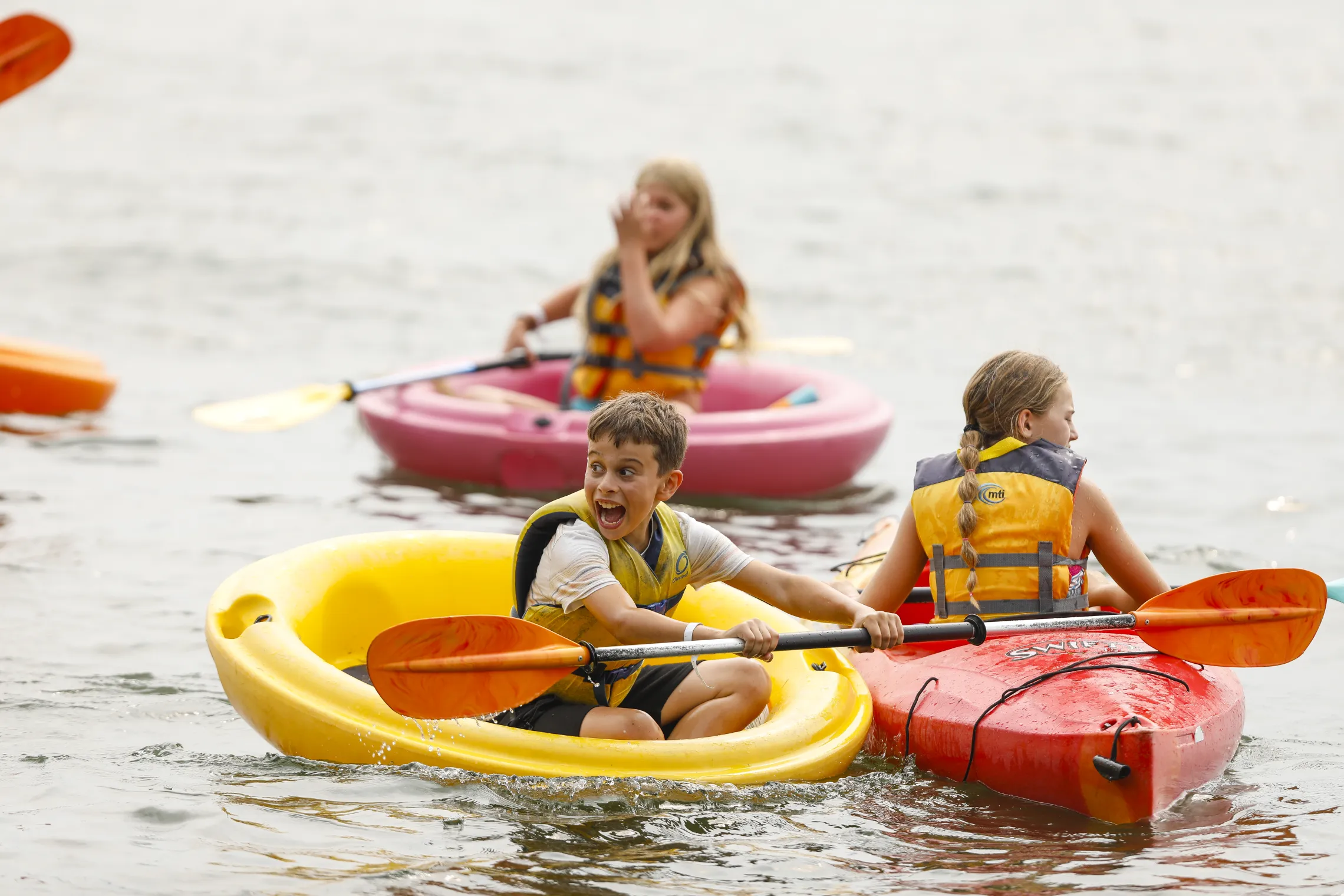Campers having fun kayaking in the lake.