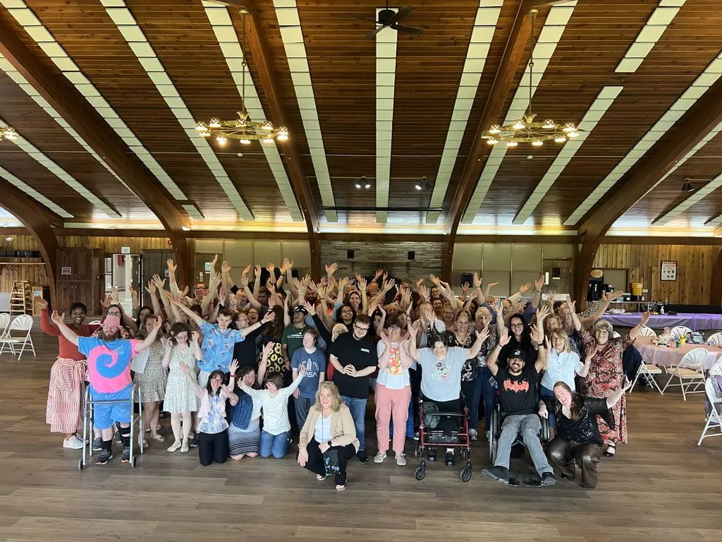 Group photo posing with arms up in excitement