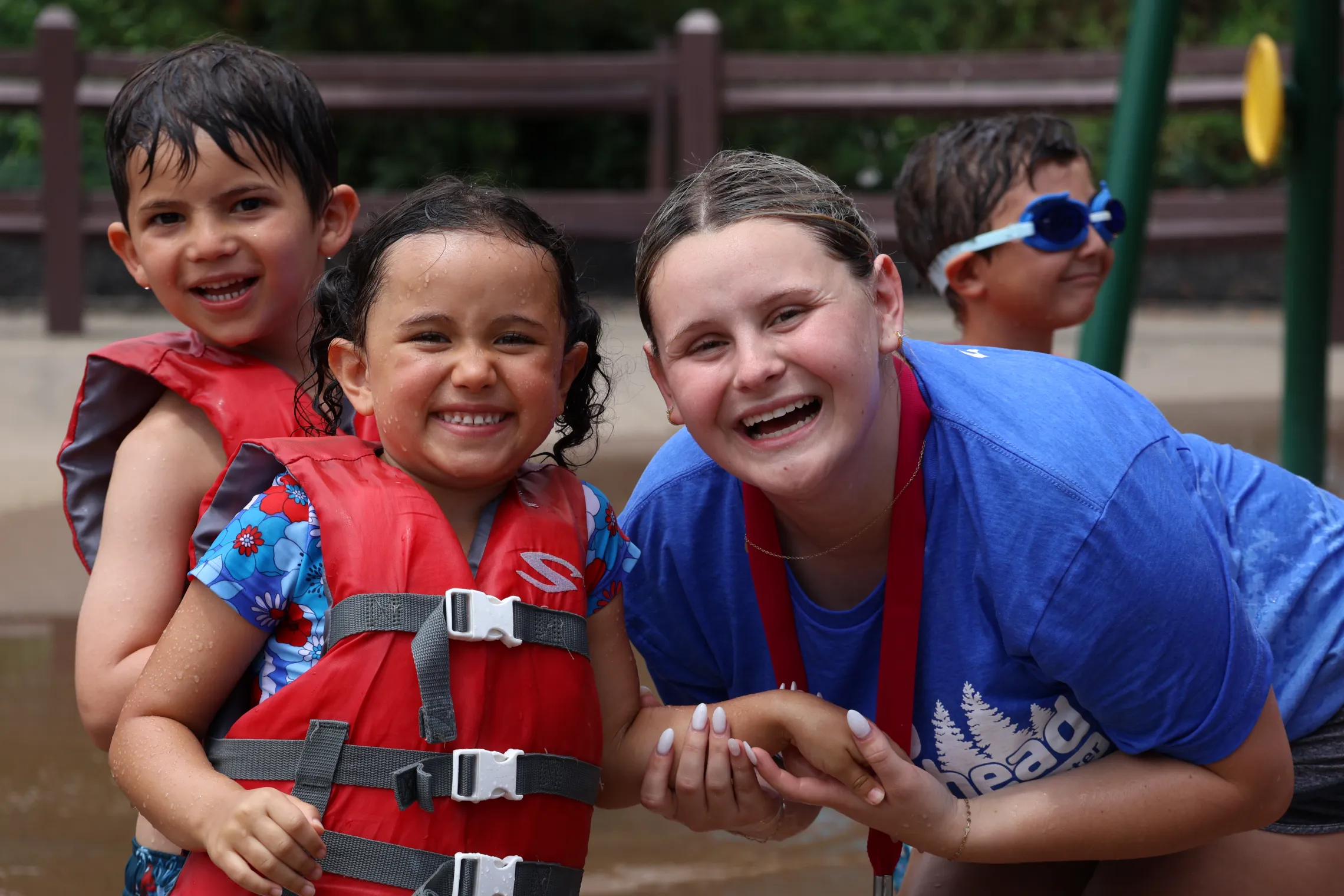 Camp counselor with campers on splash pad