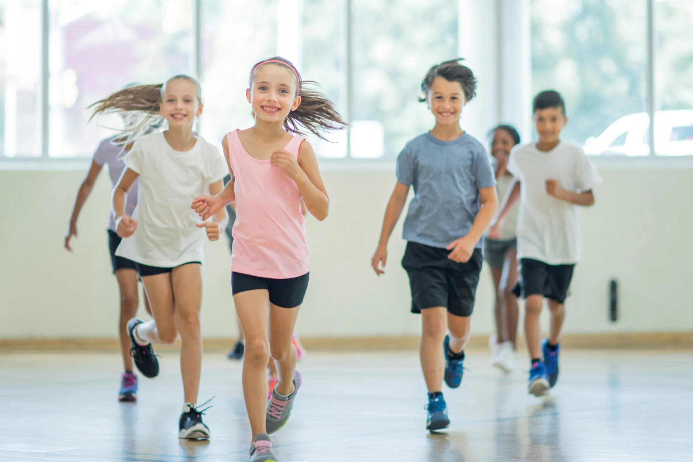 children running in a gymnasium