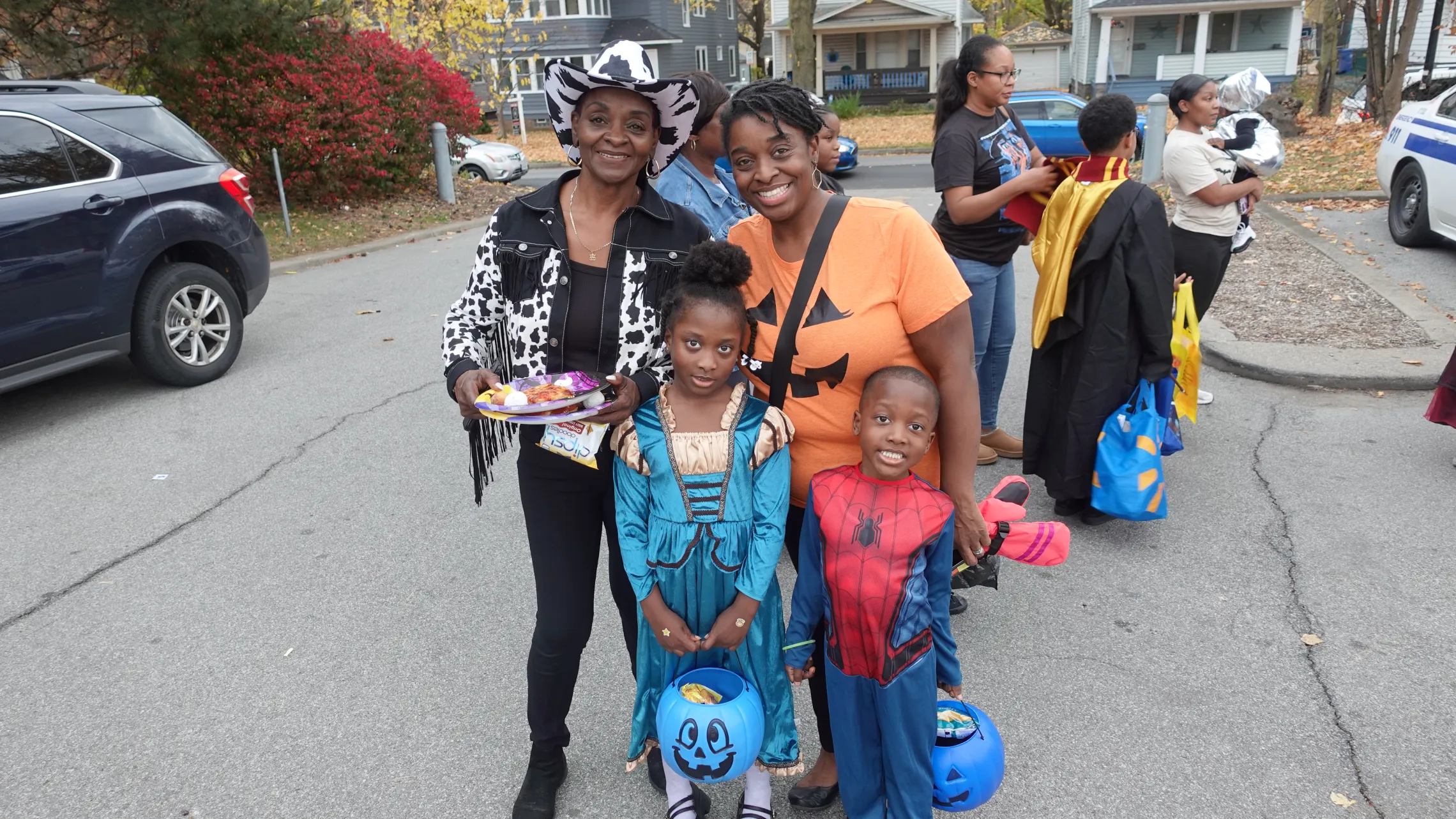 Family dressed in halloween costumes and trick or treating