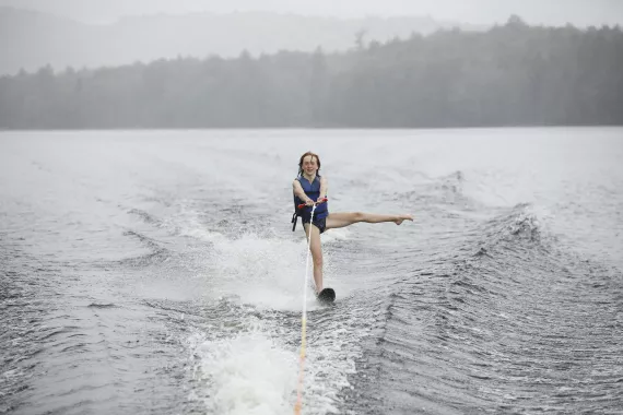 Camper waterskiing, sticking leg out