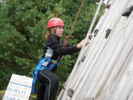 Woman on climbing wall at Camp Gorham
