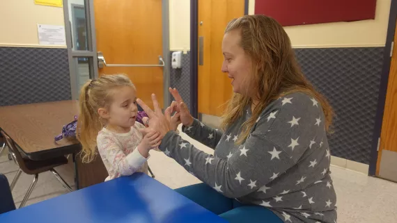 Dana Alfano plays with her daughter at the Northwest Family YMCA