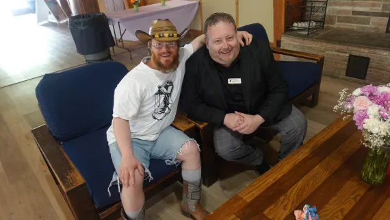 A member sits next to YMCA staff at the Spring Fling Dance